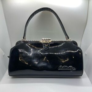 Bettie Page~Black Faux Patent Leather Sourpuss Clutch~GOOD pre-owned condition